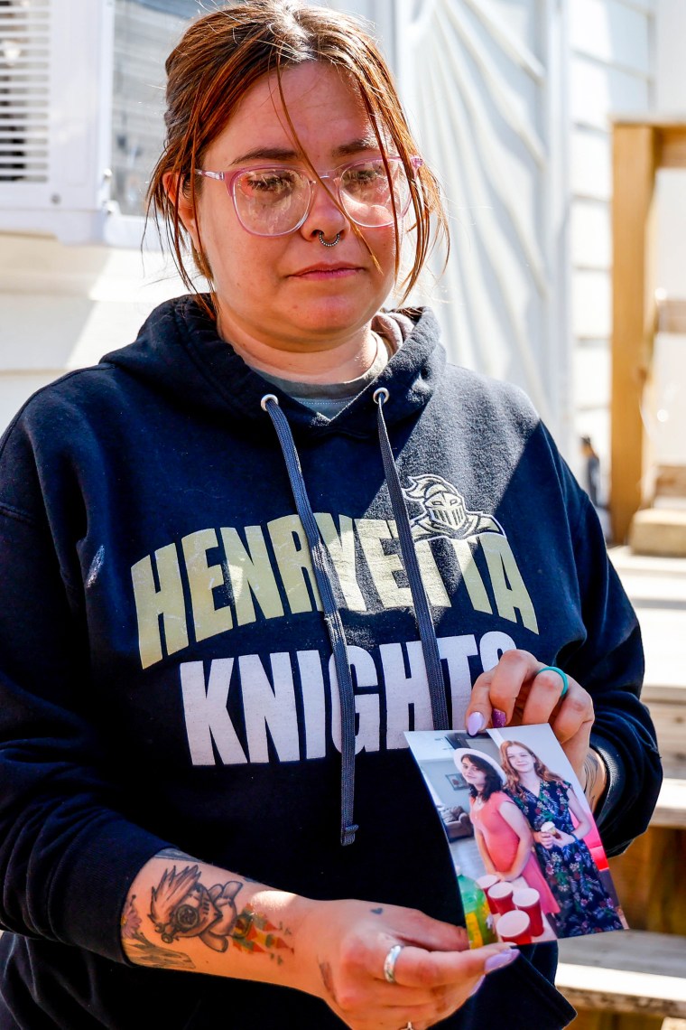 Ashleigh Webster shows a photo of Ivy Webster and Tiffany Guess at her home in Henryetta Okla., on May 2, 2023.