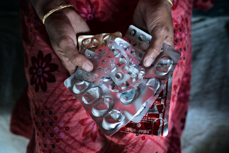 Asma Akhter holds medications she needs for uterus infections and excessive bleeding after her operation.