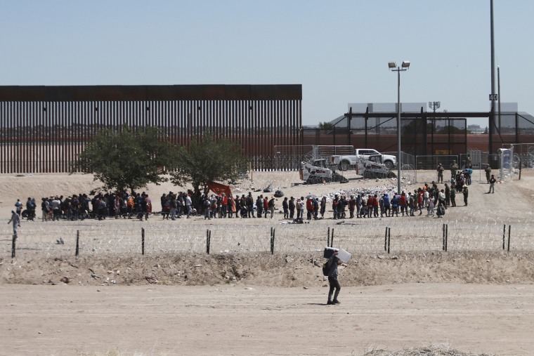 Migrants line up after being detained by US authorities at the US-Mexico border in Ciudad Juárez, Mexico on April 30, 2023. 