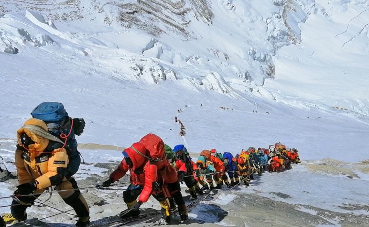 A long queue of mountain climbers line a path on Mount Everest just below camp four, in Nepal