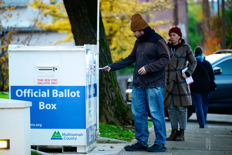 Voters cast their ballots at official ballot boxes during midterm elections on Nov. 8, 2022 in Portland, Ore.