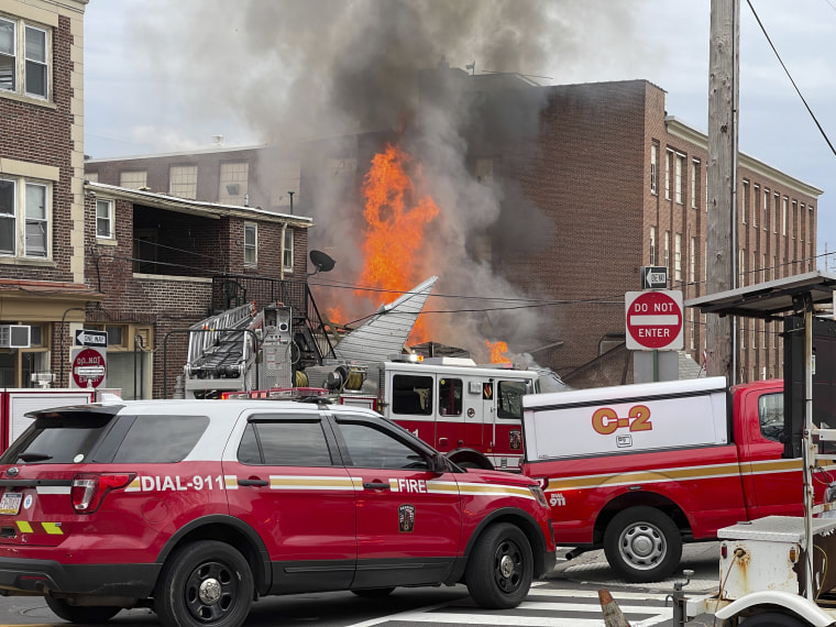 Emergency personnel work at the site of a deadly explosion at a chocolate factory in West Reading, Pa., on March 25, 2023.