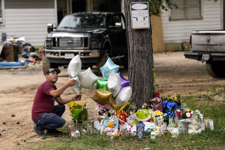 A man releases a balloon from the makeshift memorial outside the victims' home on May 2, 2023, in Cleveland, Texas.
