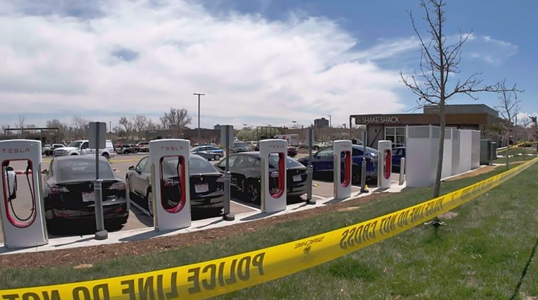Police tape at the scene of a shooting at a Tesla charging station in Edgewater, Colo., on May 3, 2023. 