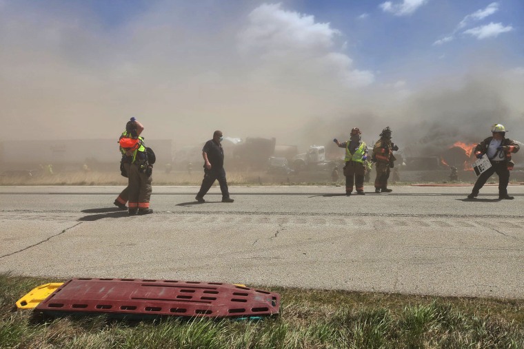 Emergency personnel at the scene of car pileup as a result of a dust storm on I-55 in Illinois on May 1, 2023.