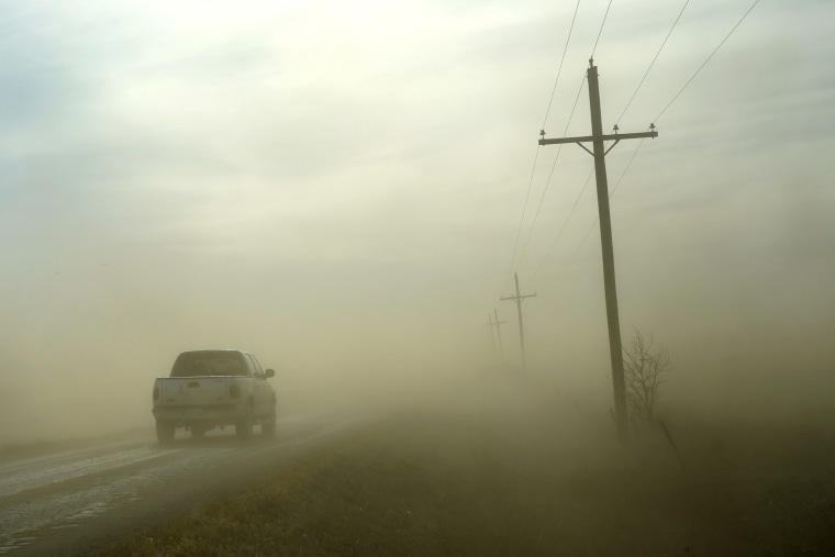A motorist drives into a dust storm near Phillipsburg, Kan., on Jan. 14, 2021.