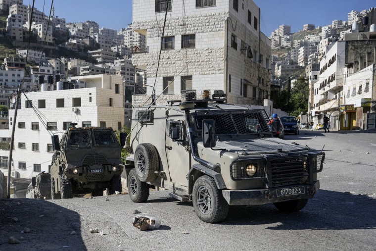 A convoy of Israeli military vehicles drives through the West Bank city of Nablus during a raid on May 4, 2023.