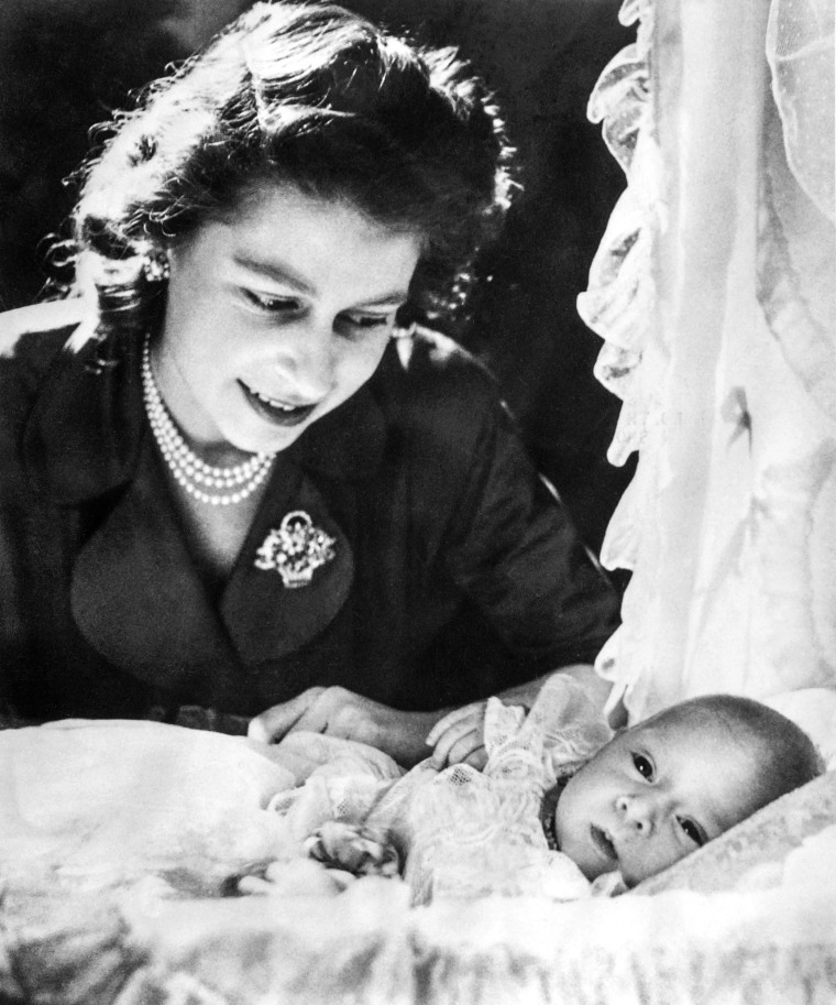 Image: Princess Elizabeth bends over baby Prince Charles on Jan. 1949.