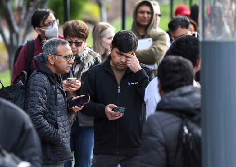 People line up outside of a Silicon Valley Bank branch on March 13, 2023, in Santa Clara, Calif.