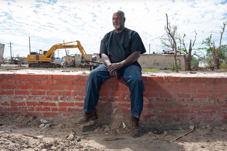 Sammy Jackson sits on all that remains of his house in Rolling Fork, Miss. 