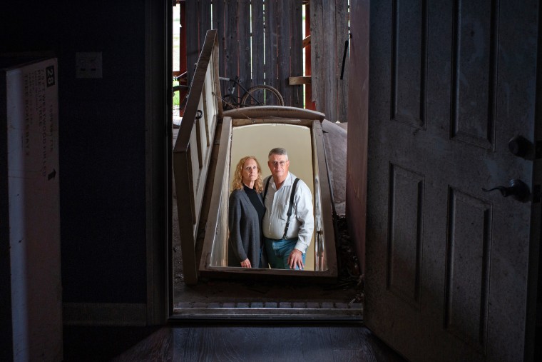 Sharon and Bill Newsom stand  inside a tornado shelter connected to their home in Rolling Fork, Miss.