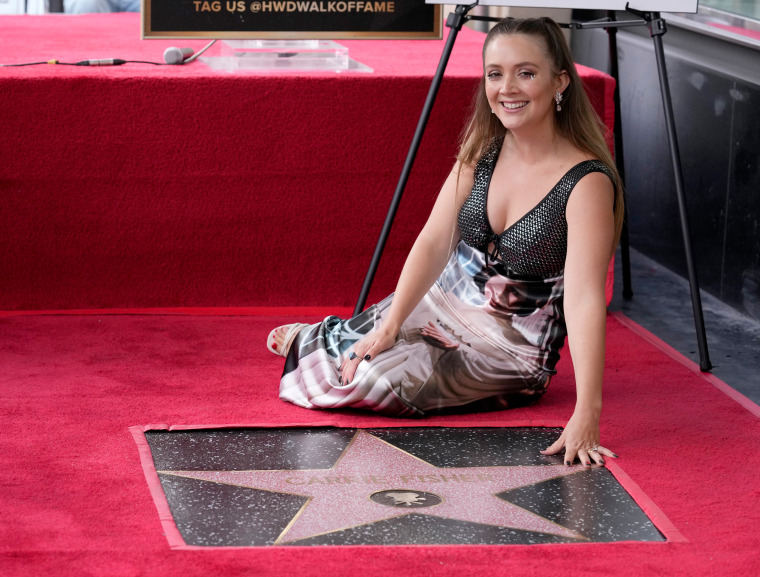 Billie Lourd, daughter of the late actress Carrie Fisher, poses atop Fisher's star on the Hollywood Walk of Fame in Los Angeles