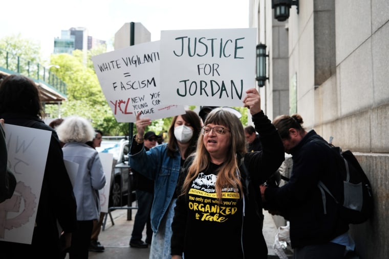 Protesters wave signs as they gather for a "Justice for Jordan Neely" rally outside of the Manhattan District Attorney's office