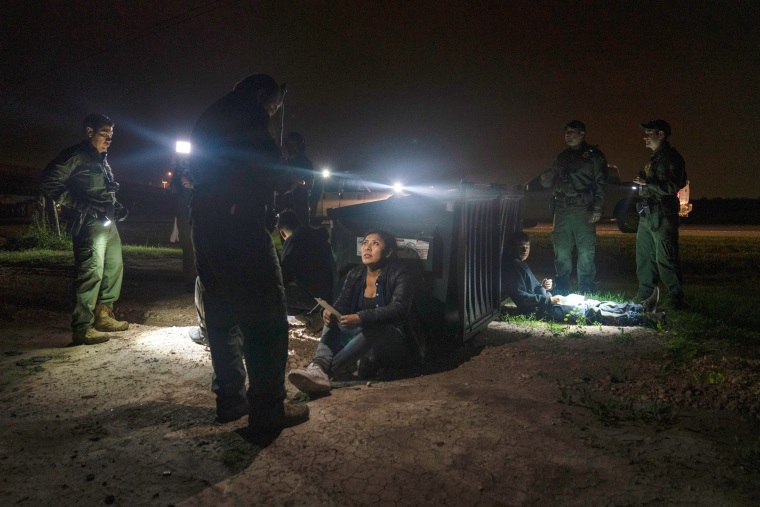 Migrants that were trying to evade U.S. Border Patrol agents, wait to be processed in Granjeno, Texas