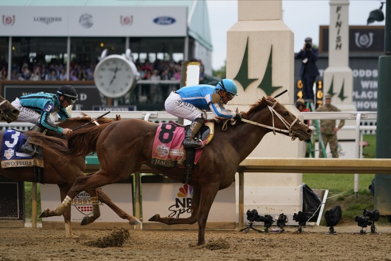 Mage (8), with Javier Castellano aboard, across the finish line to win the 149th running of the Kentucky Derby at Churchill Downs on Saturday, May 6, 2023, in Louisville, Ky. 