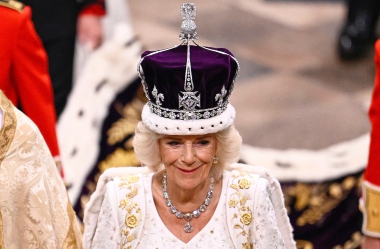Queen Camilla smiles as she wears a modified version of Queen Mary's Crown during the Coronation Ceremony