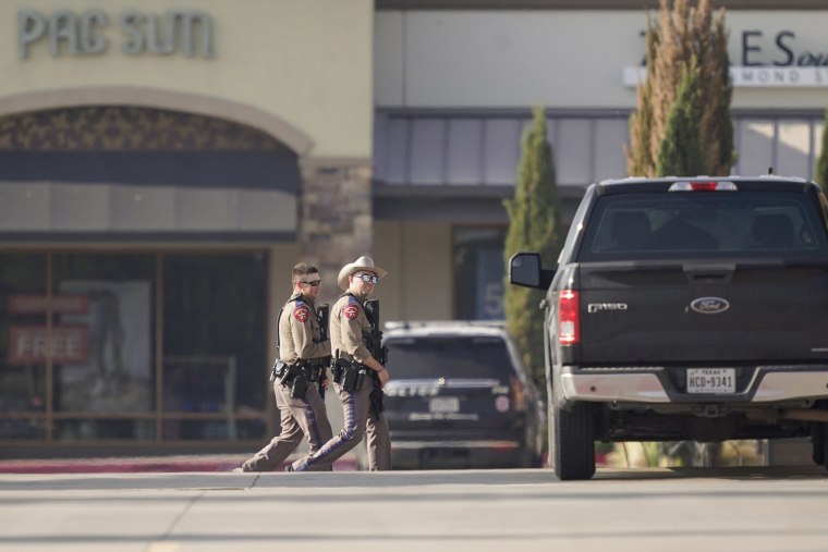 Law enforcement officers patrol at a shopping center after a shooting on May 6, 2023, in Allen, Texas.
