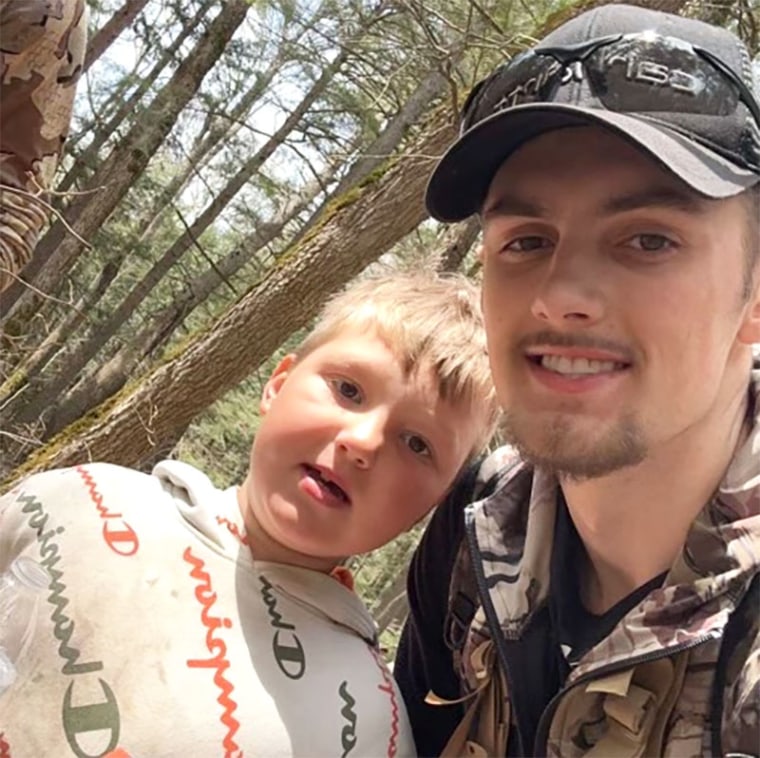 Nante Niemi, 8, stands with a volunteer after his rescue in the Porcupine Mountains Wilderness State Park in Michigan on Monday.