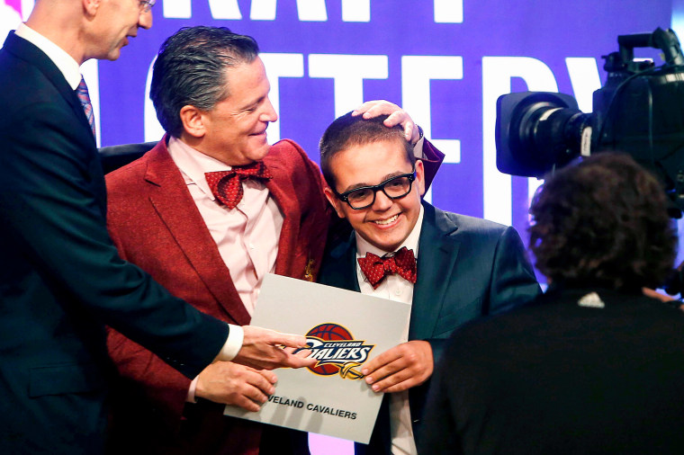 Cleveland Cavaliers owner Dan Gilbert congratulates his son, Nick Gilbert, after the team won the NBA basketball draft lottery in New York on May 21, 2013.