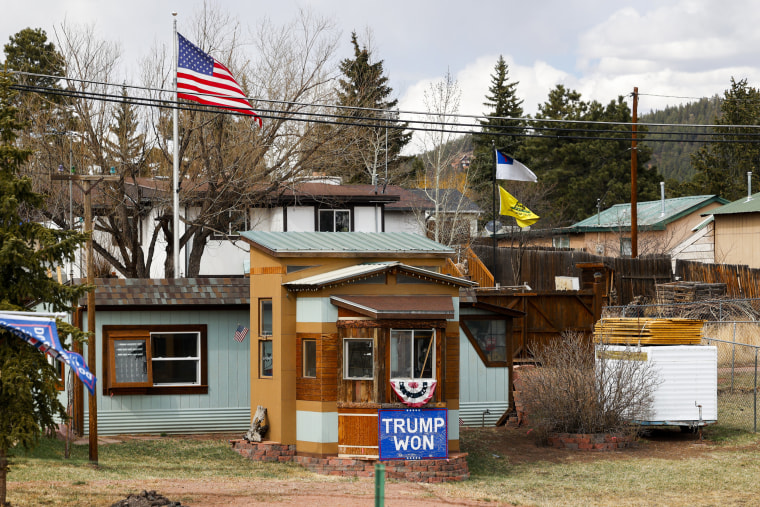 A sign supporting President Donald Trump sits in the yard of a home across from Woodland Park High School on April 12, 2023 in Woodland Park, Colo.