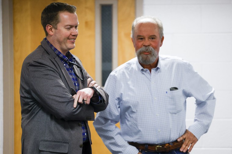 Woodland Park School Board Vice President David Illingworth II, left, and Director Mick Bates talk before the Board of Education meeting on April 12, 2023 in Woodland Park, Colo.