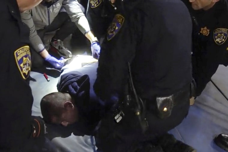 FILE - In this image taken from a nearly 18-minute video taken by a California Highway Patrol sergeant, Edward Bronstein, 38, is taken into custody by CHP officers on March 31, 2020, following a traffic stop in Los Angeles. Lawyers say California will pay a $24 million civil rights settlement to the family of a man who died after screaming "I can't breathe" while multiple officers restrained him as they tried to take a blood sample following his arrest.