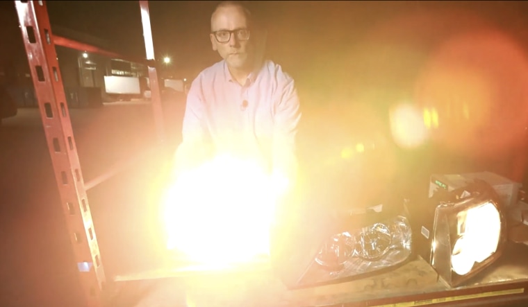 John D. Bullough lights a lamp to show the power of an LED in the eye.