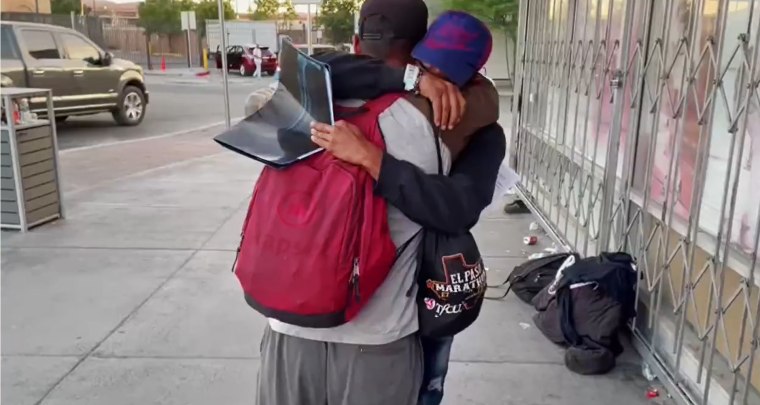 In El Paso, a father and son from Venezuela hug after they were allowed to stay in the U.S. and given a date to start the process to petition for asylum.