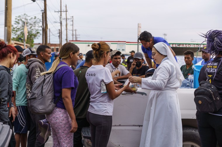 Migrants wait in line for donations outside of Sacred Heart Church before the lifting of Title 42 in El Paso, Texas, on May 3, 2023.