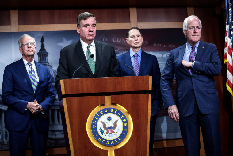 Image: Sen. Mark Warner, D-Va., joined by Sen. Jerry Moran, R-Kan., Sen. Ron Wyden, D-Ore., and Sen. John Cornyn, R-Texas, speaks on security classification reform at the U.S. Capitol on May 10, 2023.