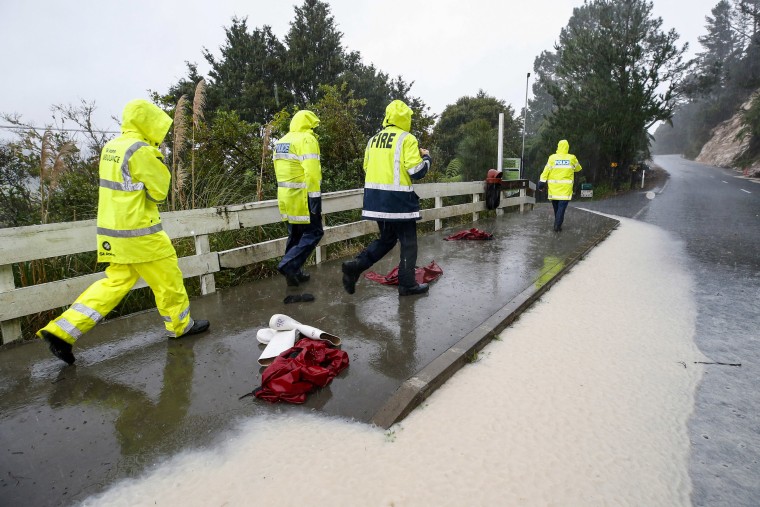 Police and rescue staff wait at a road block in the search for a student lost in caves on a school trip in Whangarei, New Zealand, on May 9, 2023.
