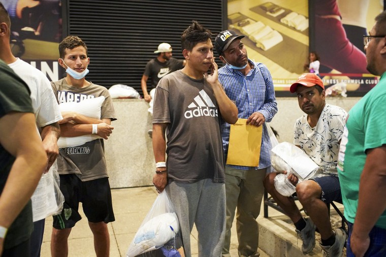 Migrants stand outside Union Station in Chicago, on Aug. 31, 2022