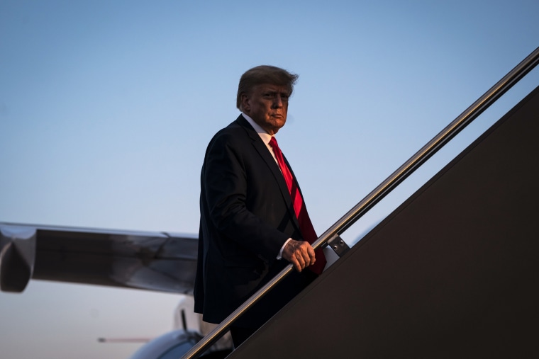 Former President Donald Trump boards his airplane after speaking at a campaign event in Manchester, N.H.