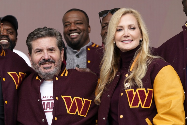 FILE - Dan and Tanya Snyder, co-owner and co-CEOs of the Washington Commanders, pose for photos after unveiling their NFL football team's new identity, Wednesday, Feb. 2, 2022, in Landover, Md. Dan Snyder has an agreement in principle to sell the Washington Commanders to a group led by Josh Harris and Mitchell Rales that includes Magic Johnson for a North American professional sports team record $6.05 billion.