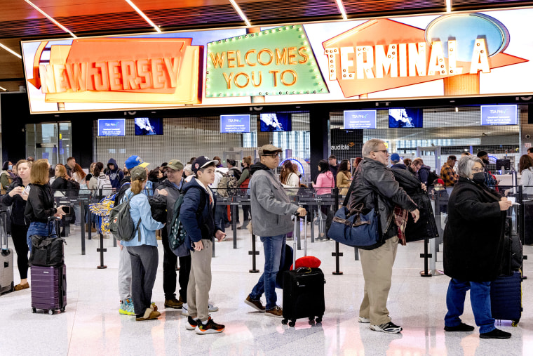 Travelers line up to go through security at Terminal A at Newark Liberty International Airport (EWR) in Newark, New Jersey on January 12, 2023. 