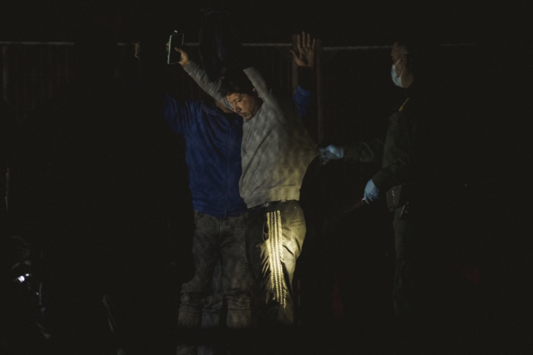 A migrant is patted down by Border Patrol agents at gate 42 in El Paso on May 12, 2023. 