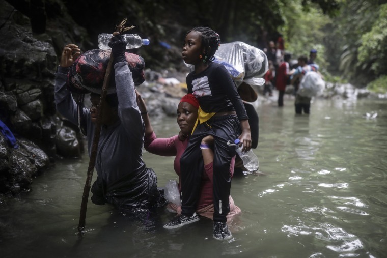 Image: Haitian migrants wade through water as they cross the Darien Gap from Colombia to Panama in hopes of reaching the U.S., on May 9, 2023.