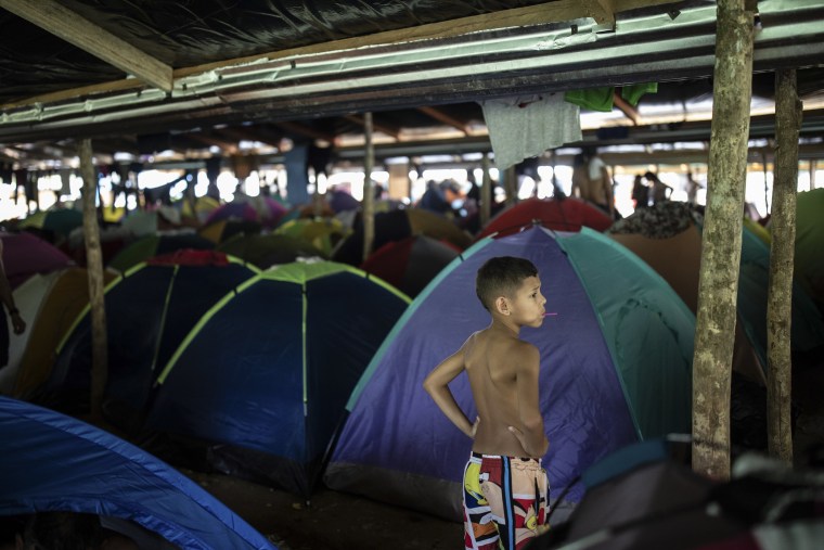 Image: A boy stands in Las Tecas camp from where migrants will start walking across the Darien gap from Colombia to Panama in hopes of reaching the US, in Acandi, Colombia, on May 8, 2023. 