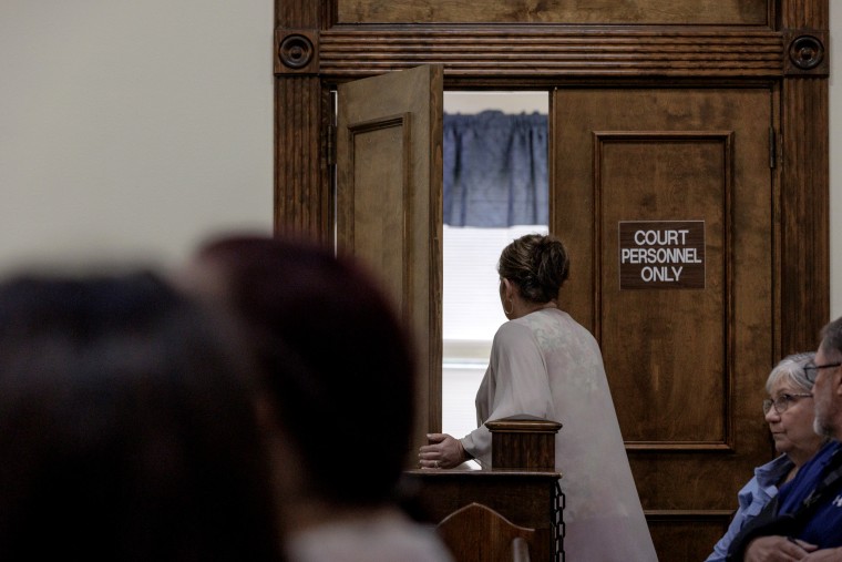 Image: Jana Bradford exits the courtroom after spotting the photographer.