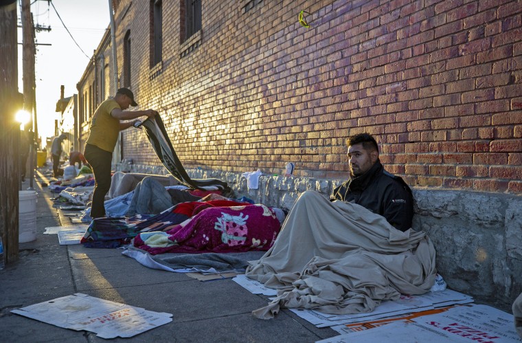 Migrants wake up at the campsite outside Sacred Heart Church in downtown El Paso, Texas, on May 9, 2023. 