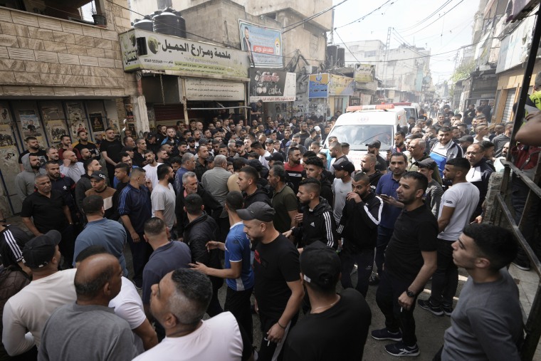Palestinian gather at the site where two Palestinians were killed during an Israeli army raid in the Balata refugee camp in the West Bank