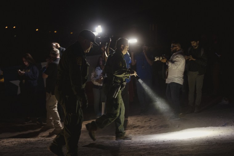 Border Patrol agents walk along the US-Mexico border in El Paso, Texas