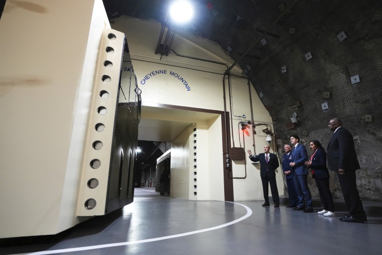 Defense Secretary Lloyd J. Austin III, Canadian Minister of National Defense Anita Anand, Canadian Prime Minister Justin Trudeau and U.S. Air Force Gen. Glen VanHerck at the Cheyenne Mountain Space Force Station facility in Colorado Springs.