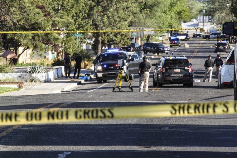 Image: Investigators work along a residential street following a deadly shooting on May 15, 2023, in Farmington, N.M. 