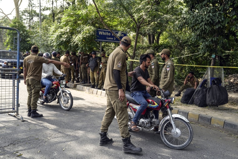 Image: Police officers search motorbikes at a temporary checkpoint around the home of Pakistan's former Prime Minister Imran Khan, in Lahore, Pakistan, on May 17, 2023. 