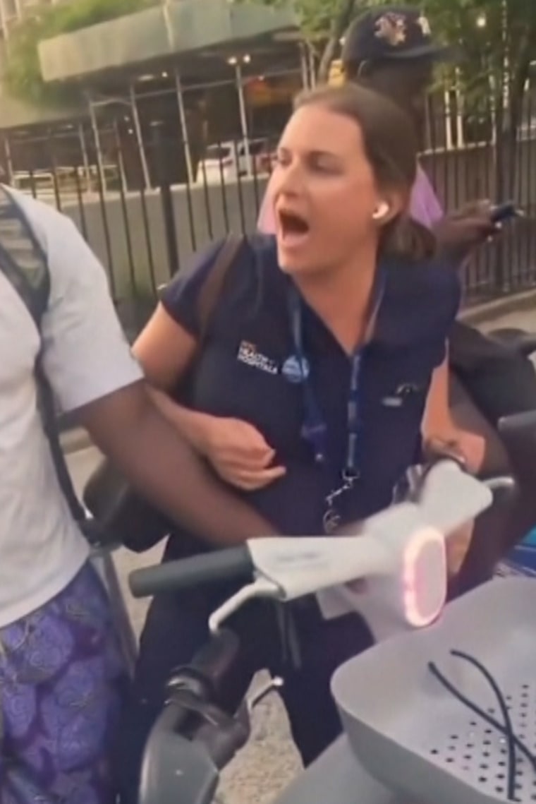 A hospital employee attempts to take a rental bike from a group of young Black men in New York.