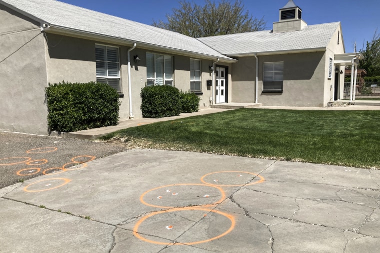 Image: Painted circles mark locations where evidence related to a deadly shooting was collected in front of a church in Farmington, N.M., on May 16, 2023. 