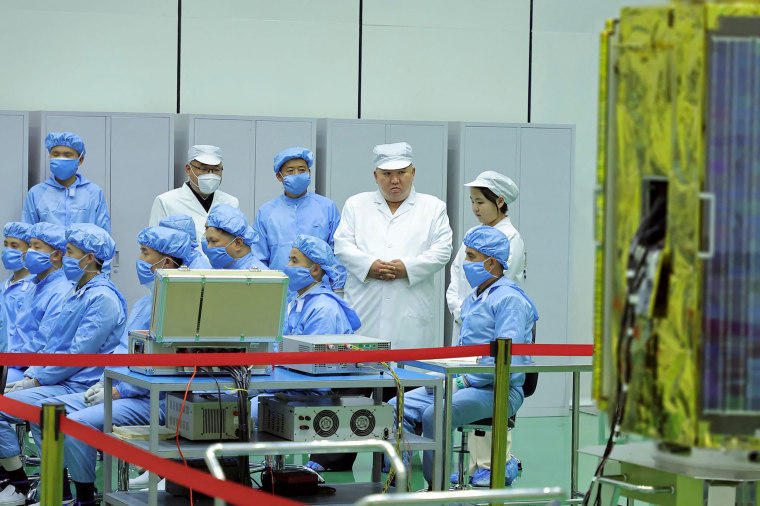 North Korea shows Kim Jong Un examining a military spy satellite that may be launched soon