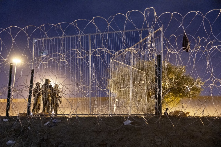 Texas National Guard troops oversee a gate at the border in El Paso, Texas
