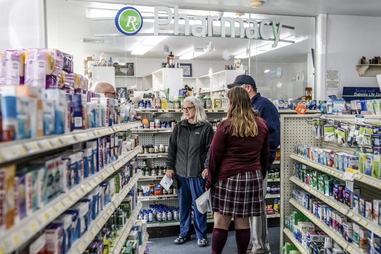 Parents wait with their daughter for her prescription at their local pharmacy in Killingworth, Conn., on Feb. 3, 2021.